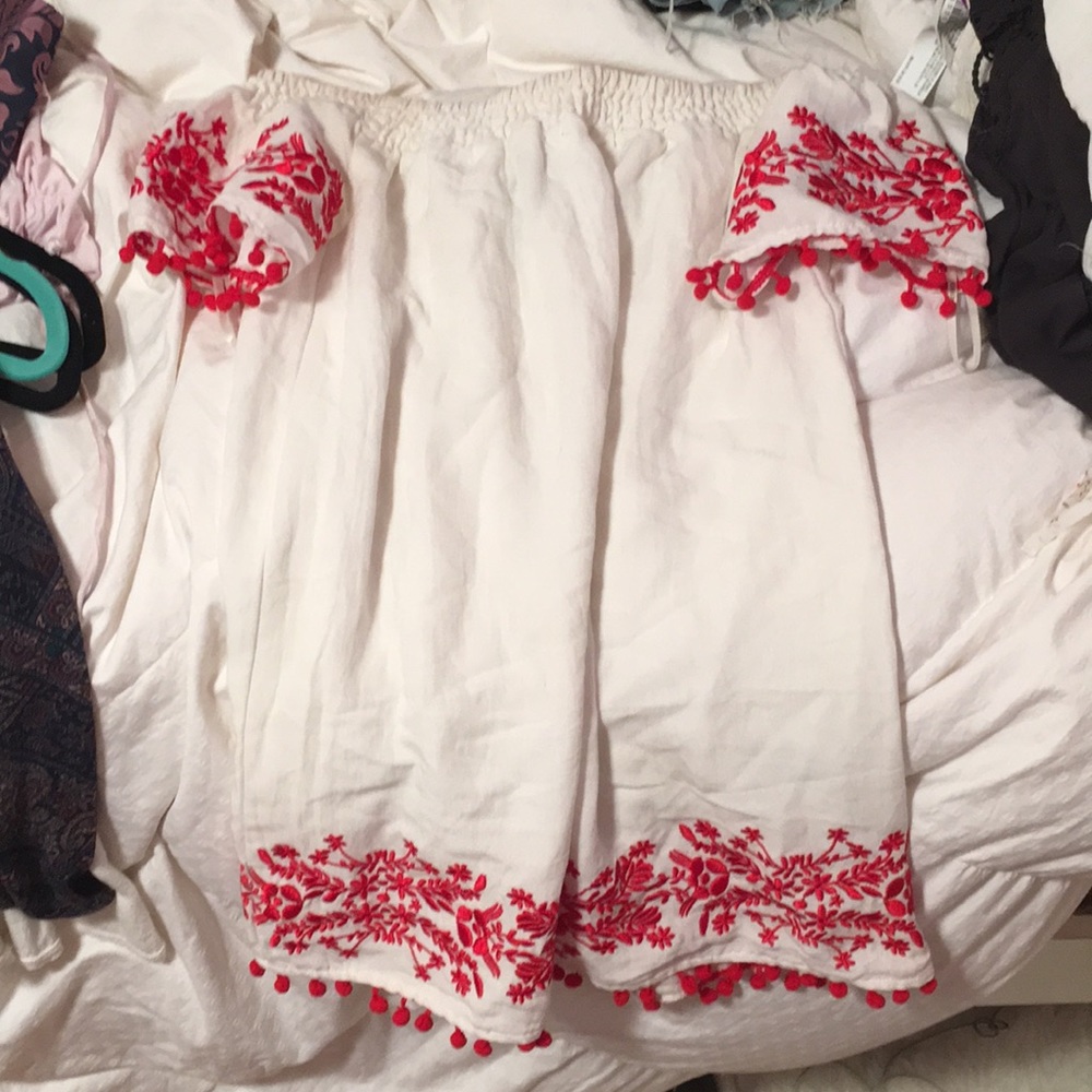 White off shoulder dress with red fringe